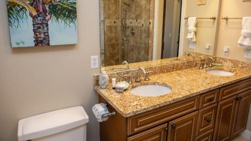 a bathroom with two sinks and a shower at Dolphin House in Santa Rosa Beach