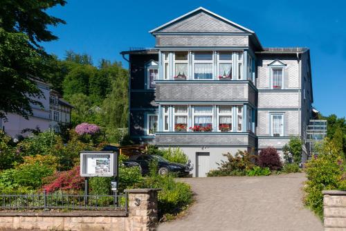 a large house with a sign in front of it at Villa Regina Fürstensuite in Friedrichroda