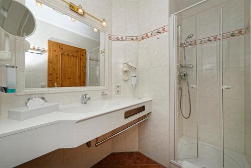 a bathroom with a sink and a shower at Ortnerhof - Ihr Zuhause am Fuße der Alpen in Ruhpolding