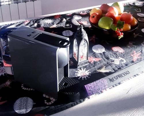 a hair dryer on a table with a bowl of fruit at Casa Mila Zlatibor in Zlatibor