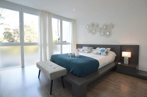 a bedroom with a large bed with a blue blanket at House 200m from Puerto de Sóller Beach in Sóller