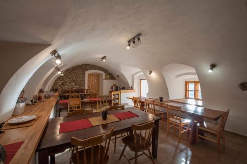 a large dining room with wooden tables and chairs at Penzion Krakovice in Kaplice
