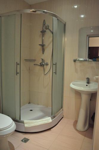 a bathroom with a shower and a sink at Vilesh Palace Hotel in Masallı