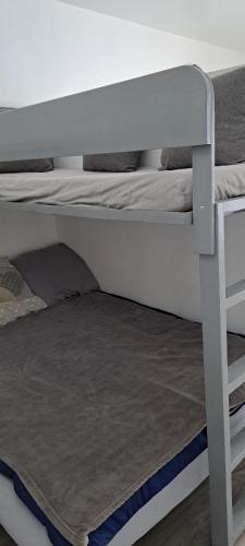 a white bunk bed with a rug on the floor at Aux pieds des pistes refait à neuf in Superdevoluy