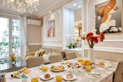 une salle à manger avec une table sur laquelle se trouve de la nourriture dans l'établissement Chaleureux 100m2 3CH - Séjour Romantique Parfait, à Paris
