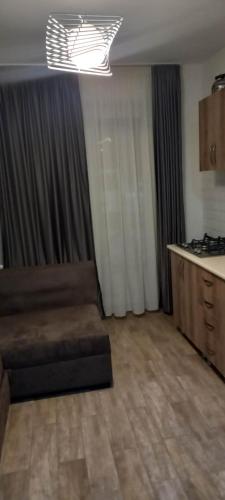 a living room with a couch and a kitchen at X2 bakuriani in Bakuriani