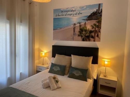 1 dormitorio con 1 cama con 2 lámparas y una foto en la pared en Hostal Ventura Premium en Alicante