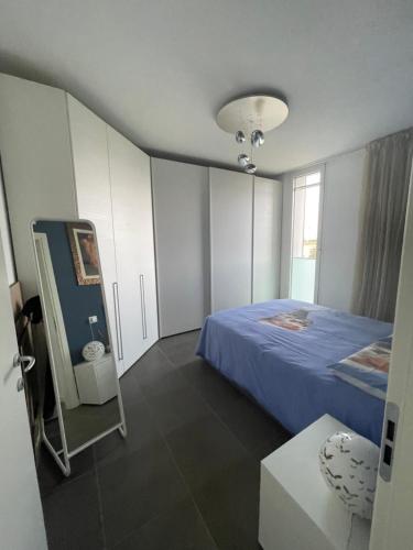 a bedroom with a blue bed and a window at Casa Mina in Assago