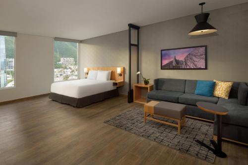 ein Wohnzimmer mit einem Bett und einem Sofa in der Unterkunft Hyatt Place Monterrey Valle in Monterrey