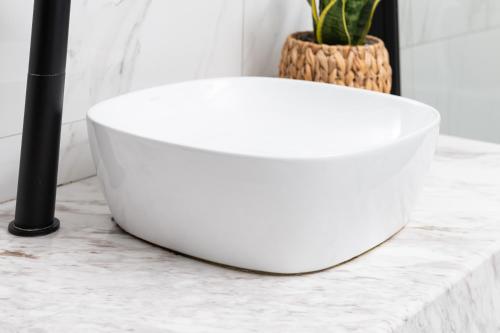 a white bowl sitting on a counter with a plant at Enattica Suites in Athens