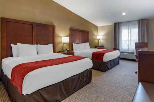 a hotel room with two beds and a window at Comfort Inn Glenmont - Albany South in Glenmont