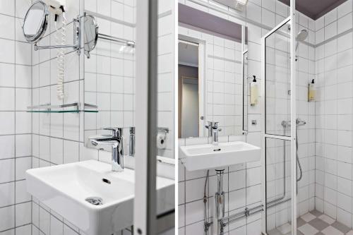 a white bathroom with a sink and a shower at Voksenasen Hotell; Best Western Signature Collection in Oslo