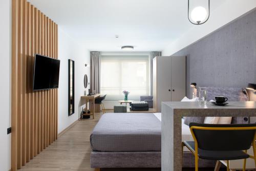 a living room with a bed and a dining room at Enattica Suites in Athens