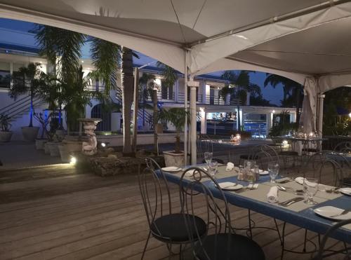 a table with chairs and an umbrella on a deck at SugaLove Villa 30 Flamboyant Ave in Saint James