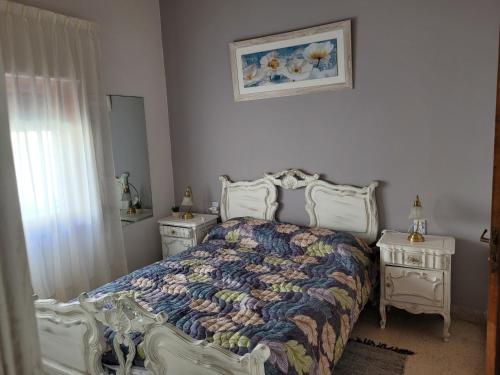a bedroom with a bed and two night stands at Casa frente al mar Monte Hermoso in Monte Hermoso