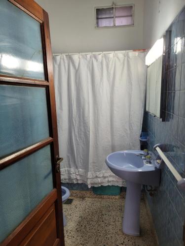a bathroom with a sink and a toilet and a shower at Casa frente al mar Monte Hermoso in Monte Hermoso