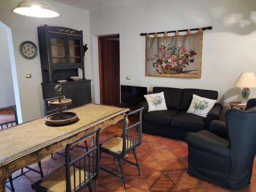 a living room with a couch and a table at Poggio Delle Palme in Campobello di Licata