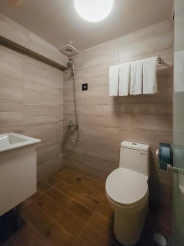 a bathroom with a white toilet and a sink at Taipei Inn in Taipei