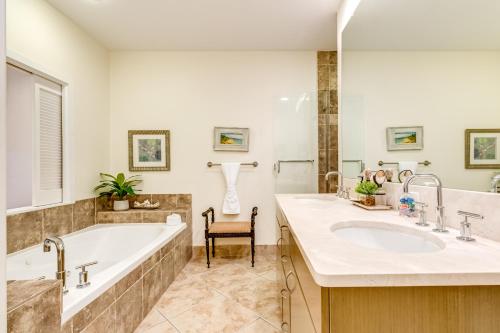 a bathroom with two sinks and a bath tub at Diamond Beach Resort Seawall Stunner in Galveston