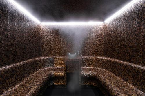 a dark room with a light on a brick wall at EPIC SANA Marquês Hotel in Lisbon
