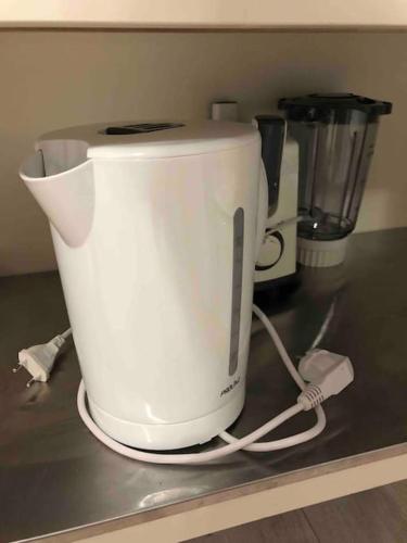 a white appliance sitting on top of a counter at Milly COCOON / centre ville in Milly-la-Forêt
