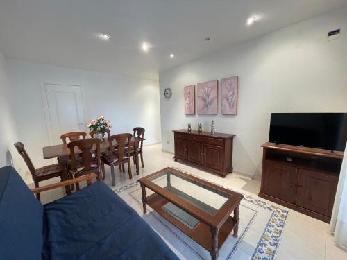 a living room with a couch and a table at APCOSTAS Cala Gonzalez in Alcossebre