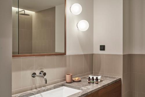 a bathroom with a sink and a mirror at The Social Athens Hotel, a member of Radisson Individuals in Athens