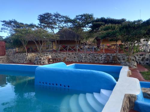 a pool at a resort with a building in the background at Ngari Hill EcoLodge, Maralal - Kenya in Maralal