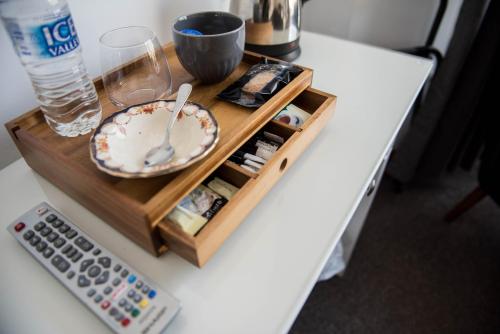 a table with a remote control and a plate on a tray at The George Hotel in Kirton in Lindsey