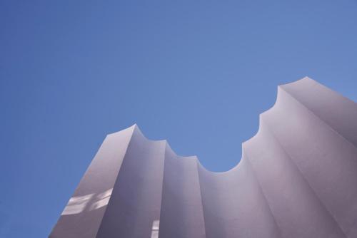 a tall white building with a blue sky in the background at The Social Athens Hotel, a member of Radisson Individuals in Athens