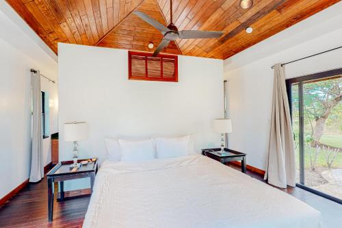 a bedroom with a white bed and a ceiling fan at Zumba House at The Reserve Gold Standard Certified in Hopkins