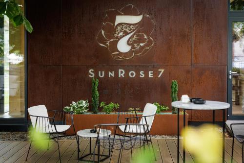 a table and chairs in front of a sunoco restaurant at Boutique Hotel Sunrose 7 - Gourmet & SPA in Bohinj
