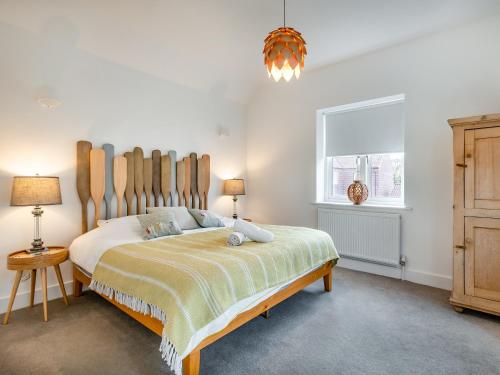 a bedroom with a large bed and a window at Schaels Retreat in Binham