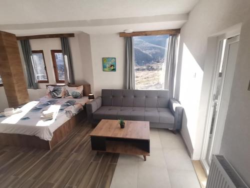 a living room with a couch and a coffee table at Villa ANA-Mavrovo in Mavrovo