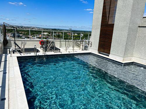 a swimming pool on top of a building at Studios Cityhome Maxplaza Canoas in Canoas