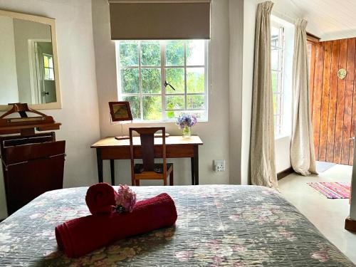 a bedroom with a red teddy bear on a bed at Woodcroft in Lidgetton