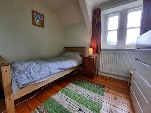 a small bedroom with a bed and a window at Simonside Cottage nr Rothbury in Morpeth