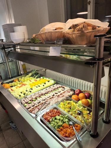 a buffet line with many different fruits and vegetables at Opitzův dům in Prague