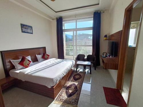 a bedroom with a bed and a large window at Blessings Always Homestay in Dehradun