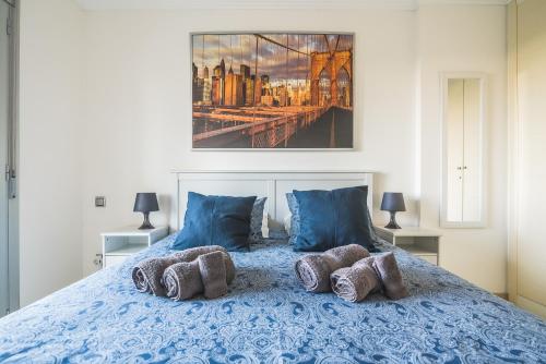 a bedroom with a blue bed with blue pillows at Home2Book Comfy Apartment Rambla in Las Palmas de Gran Canaria