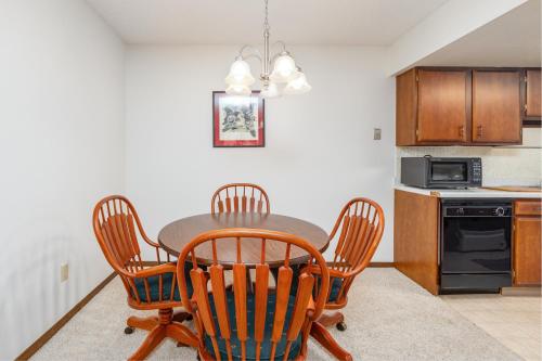 a kitchen with a table and chairs and a microwave at Skiview #103 in Girdwood