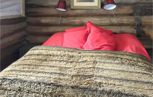 a bedroom with a red bed with a red pillow at Lovely Home In Vemdalen With Sauna in Vemdalen