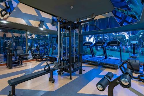 a gym with lots of treadmills and machines at Mövenpick Resort Antalya Tekirova - Ultra All Inclusive in Tekirova