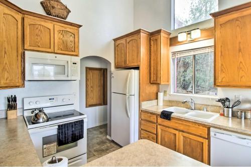 a kitchen with wooden cabinets and a white refrigerator at Lake View Home with Grill Hike, Boat, Relax! in Kelseyville