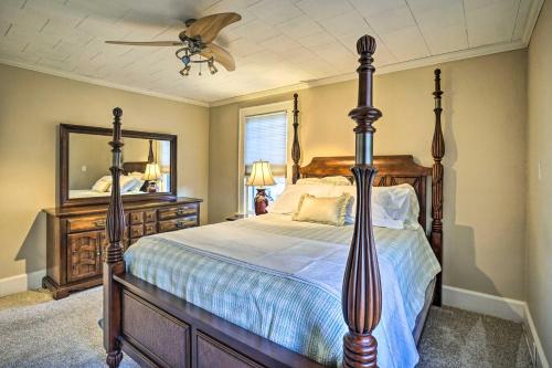 a bedroom with a large bed and a mirror at Charming and Family-Friendly Zanesville Home! in Zanesville