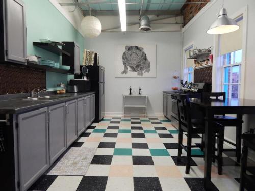 a kitchen with a checkered floor and a table and chairs at Riverfront Loft Apt A in Salisbury