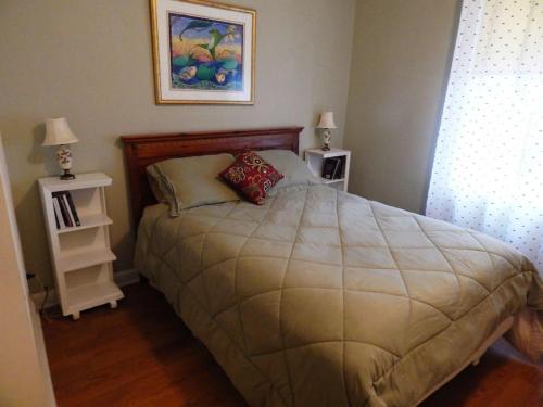 a bedroom with a large bed with two night stands at Riverfront Loft Apt A in Salisbury