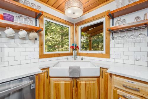 a kitchen with a sink and a window at Moose Meadow Chalet in Girdwood