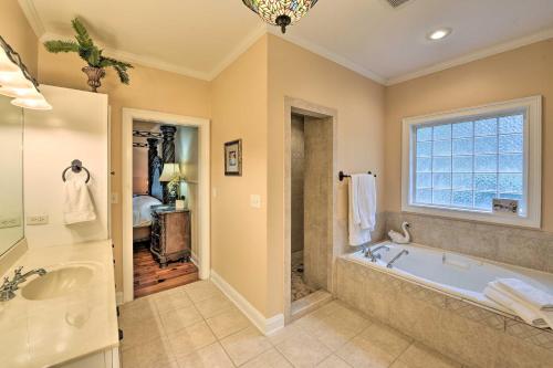 a large bathroom with a tub and a sink at Spacious Statesboro House with Private Pool! in Statesboro