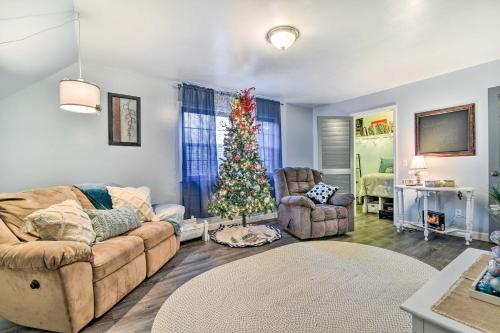 a living room with a christmas tree and a couch at Clio Apt on 3 Acres, 14 Mi to Frankenmuth! in Birch Run